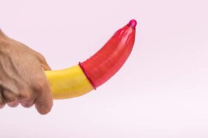 Close-up banana with red condom on it