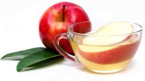 Glass of apple juice tea cyder with leaf