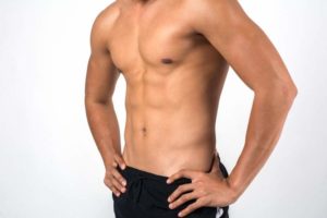 Muscular man showing six pack abs