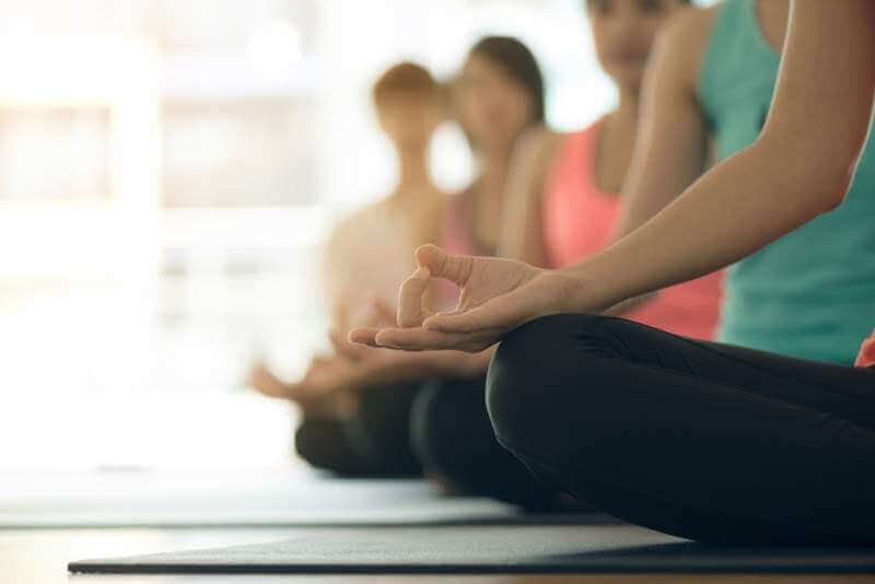 Young women yoga indoors keep calm and meditates while practicing yoga to explore the inner peace