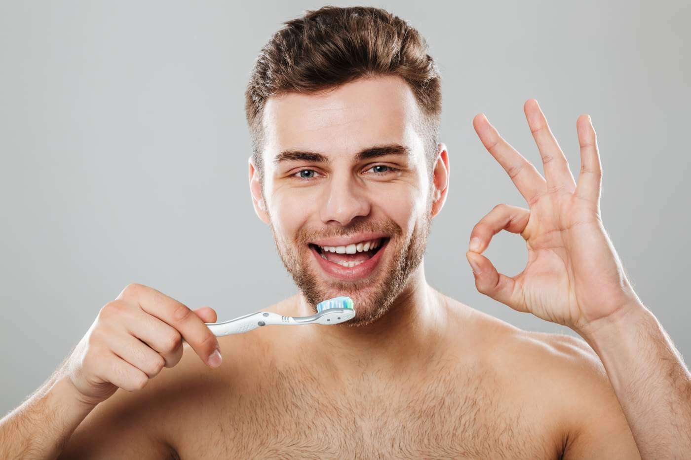 happy half naked man tooth brush