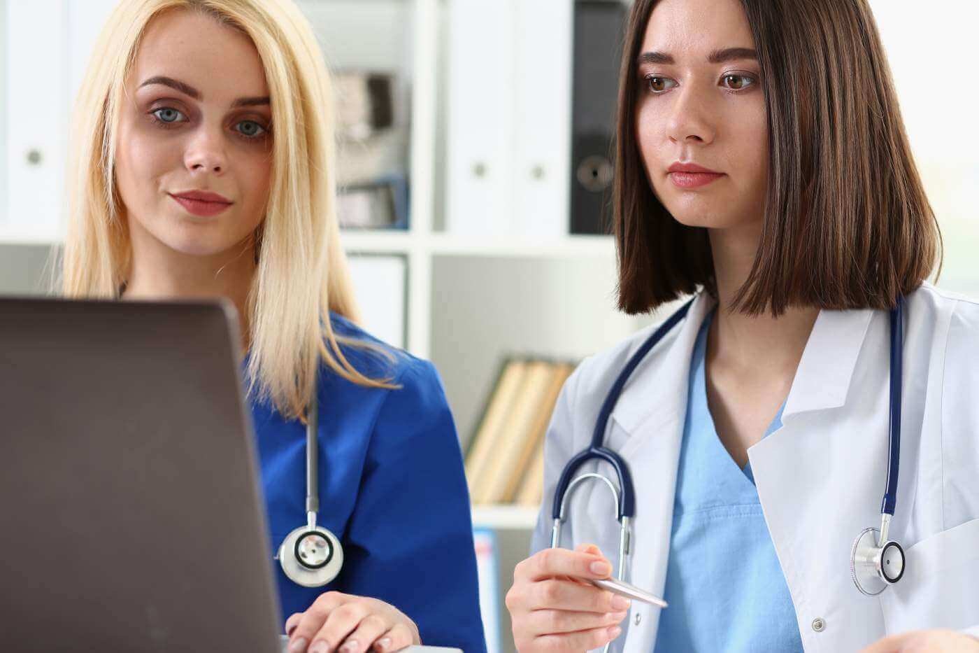 Group of doctors using laptop pc sitting in office