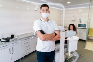 Dentist posing in the office with patient