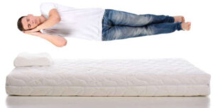 Young-man-sleeping-on-a-mattress-flying-during-sleep