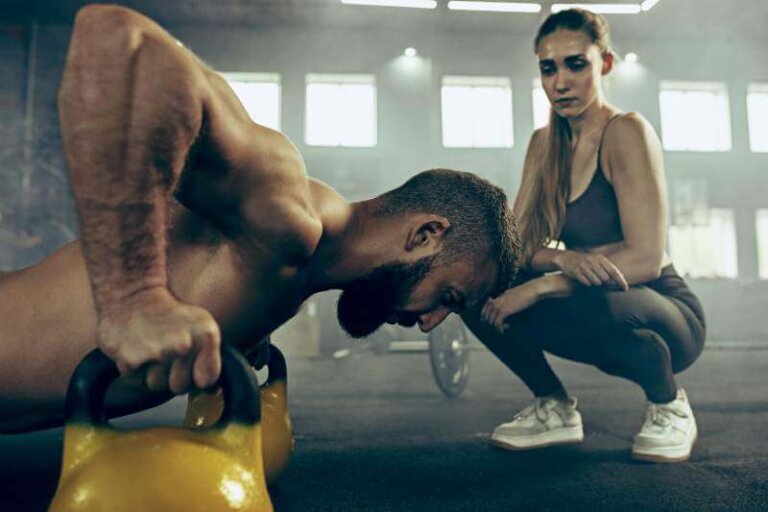 fit-young-man-lifting-barbells-working-out-gym