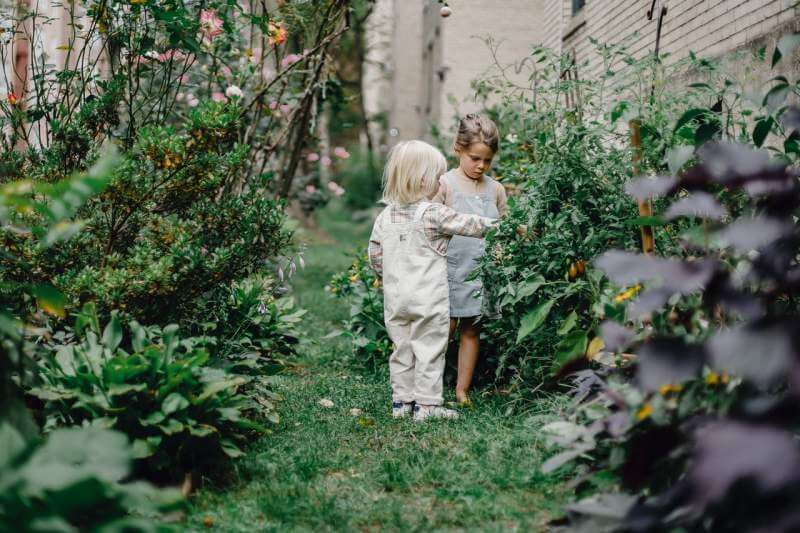 calm-stylish-children-spending-time-together-in-garden