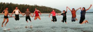 people-happy-jumping-beach