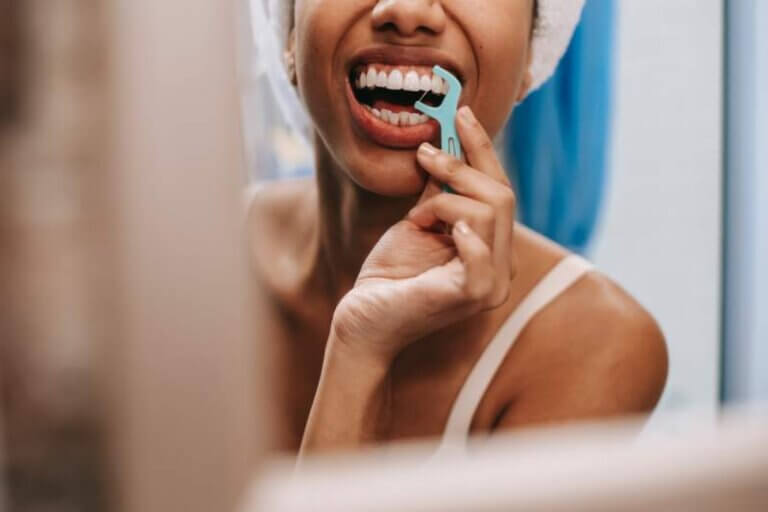 reflection-of-woman-cleaning-teeth